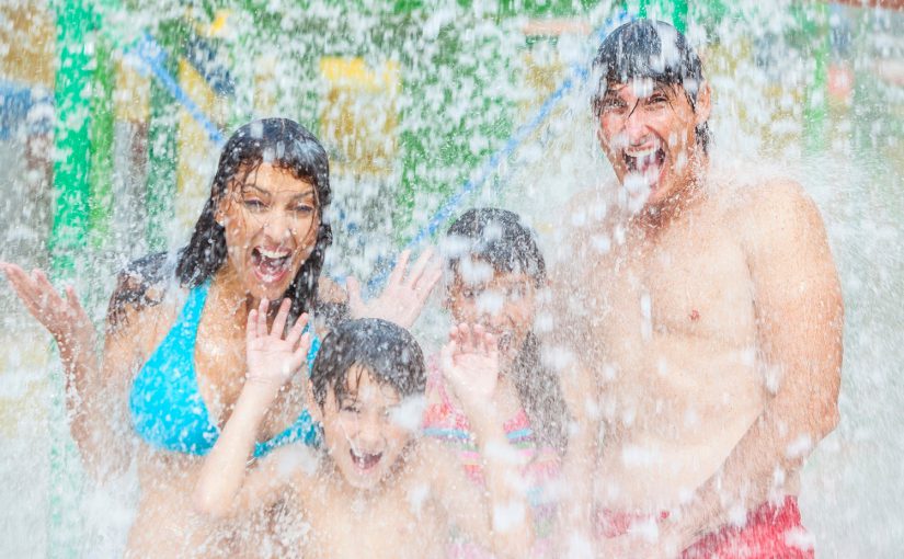 A happy family of mother, father and children, son and daughter, having fun on vacation at a water park; Finger Lakes Family Vacation