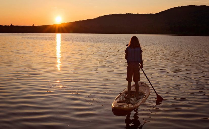 paddleboarder in sunset; finger lakes paddleboard rental