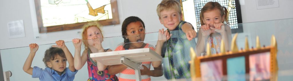 Children pointing at something in a museum